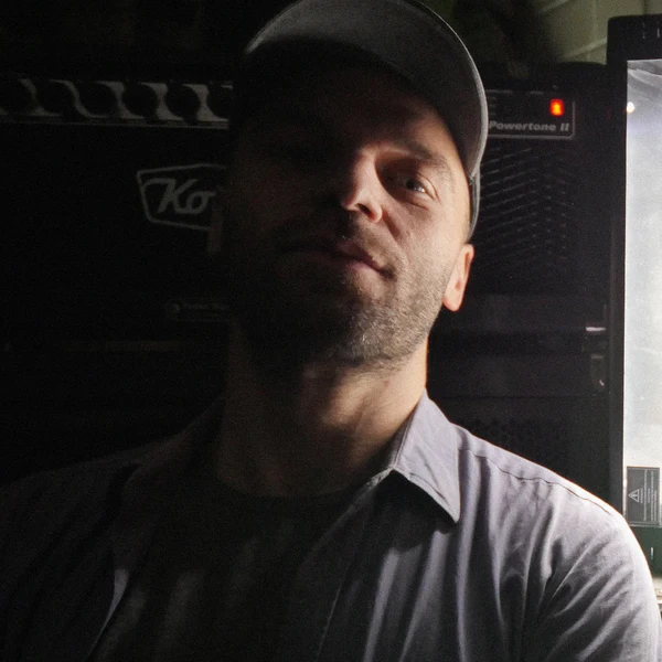 Picture oF Davicde Luciani in front of a amplifier.
