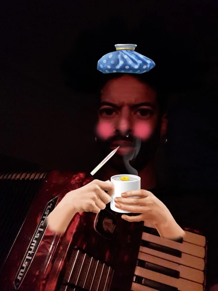 Picture of NDNMK solutions with a cup of tea and an accordion.